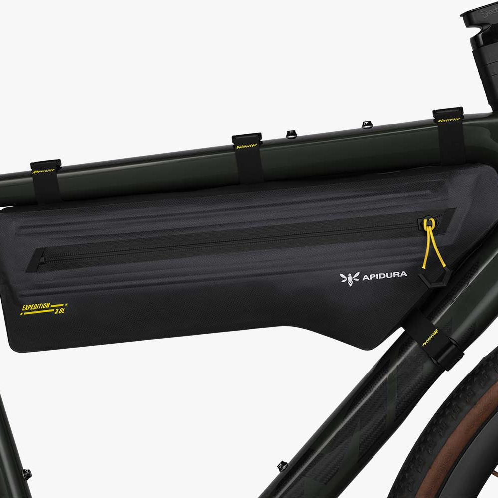 Bicycle frame with a black Apidura bikepacking bag on a white background