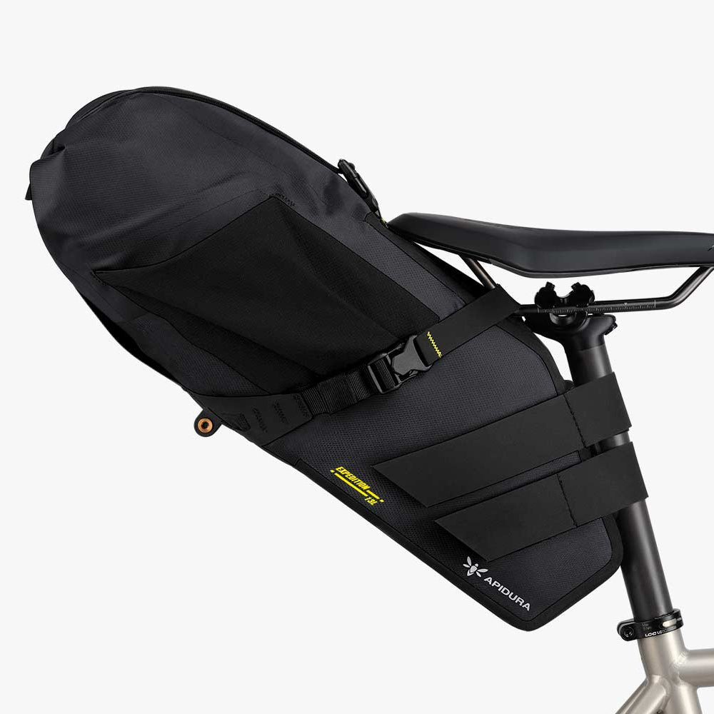 Black bike seat bag attached to a bicycle frame on a white background