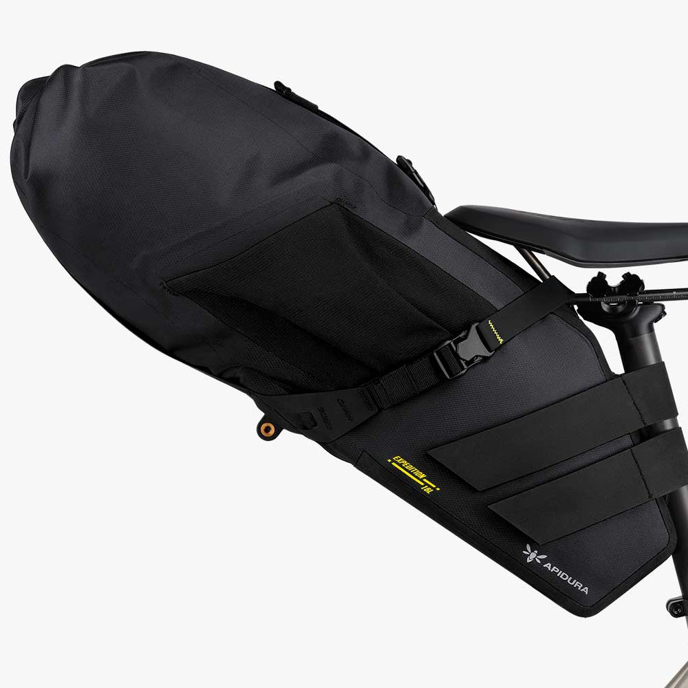 Black bicycle seat pack attached to a bike frame on a white background