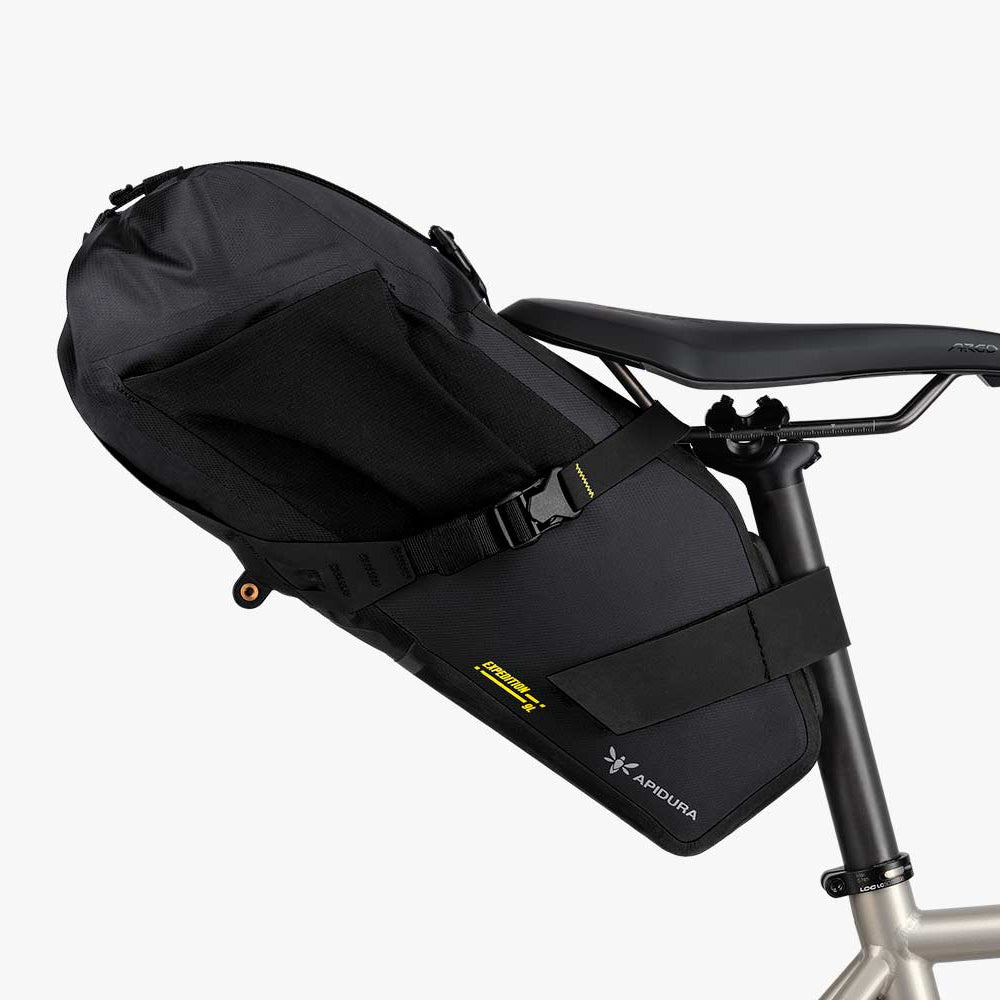 Black bicycle seat pack attached to a bike seat on a white background